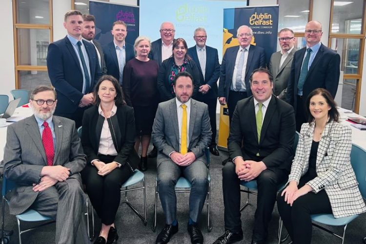 A group of professionals in business suits and ties seated on chairs, posing for a picture